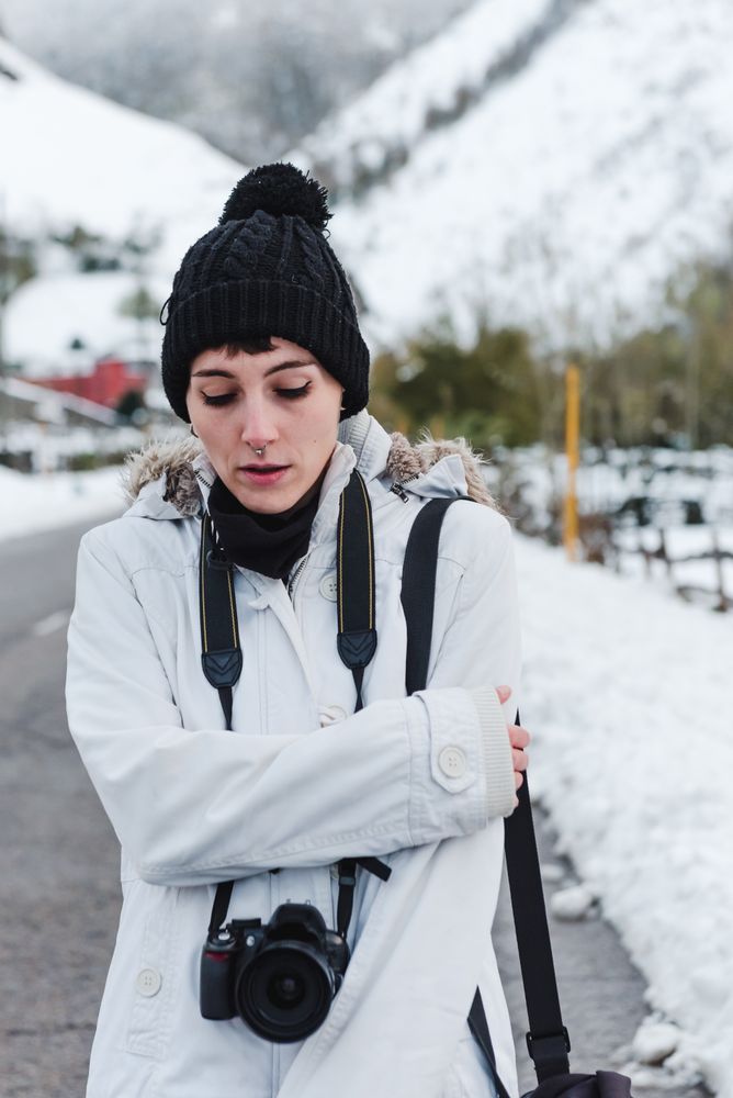 Woman walking in snowy mountains