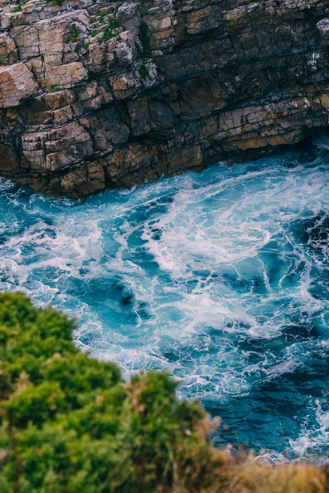 Sea waves crashing near cliff