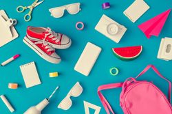 Back to school supplies on bright blue background