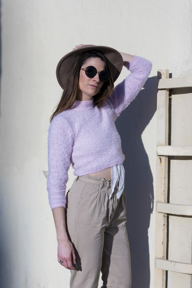 Front view of young woman wearing sunglasses and hat