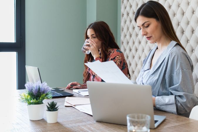 Focused women working on laptops in coworking space