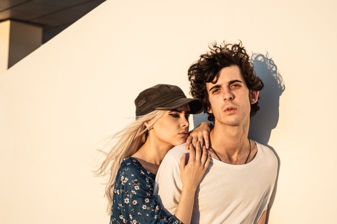 Couple leaning on wall contemplating