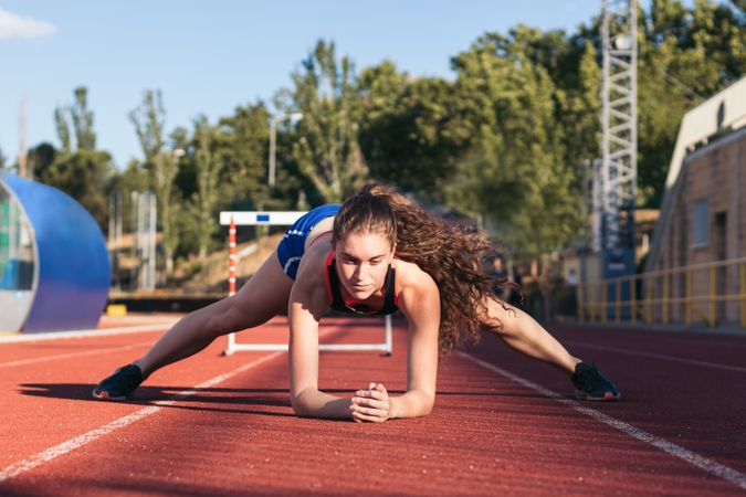 A female athlete warming up before running.