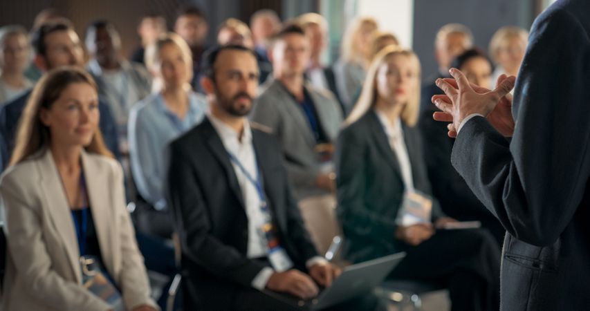 Back View, Focus on Hand Gestures Of Startup CEO Pitching Product Or Service to Room Full of Diverse Investors.