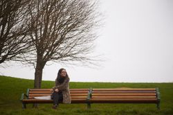 Woman on bench in foggy park