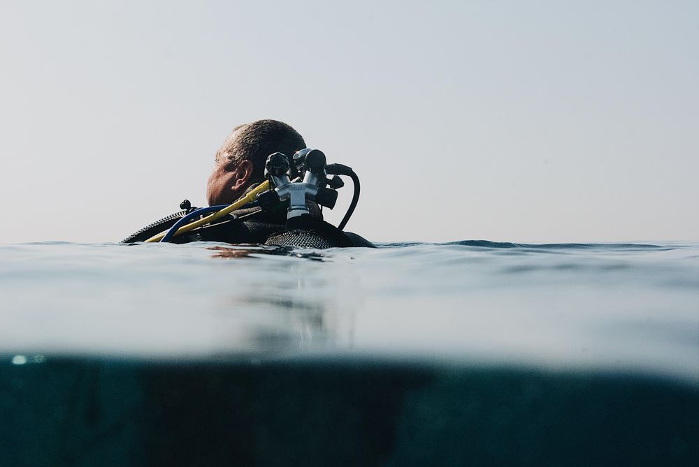 Man in water with oxygen bottle