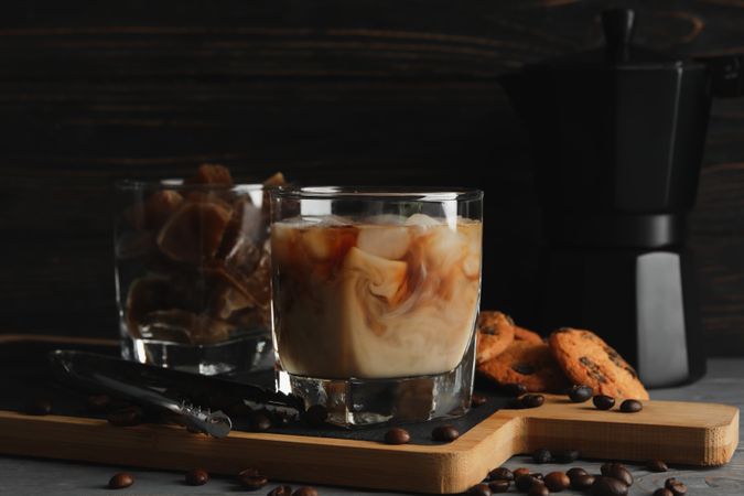 Composition with ice coffee and cookies on wooden background