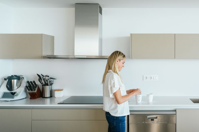 Woman making tea in kitchen