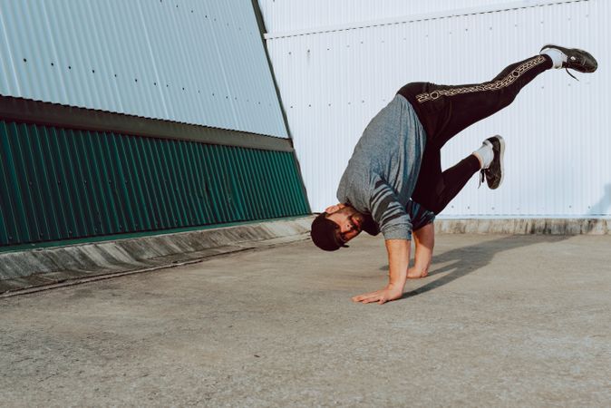 Man performing handstand near wall
