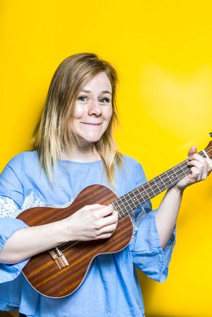 Woman enjoying playing ukulele