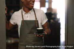 Cropped shot of barista standing at a café wearing apron 0PVJO4