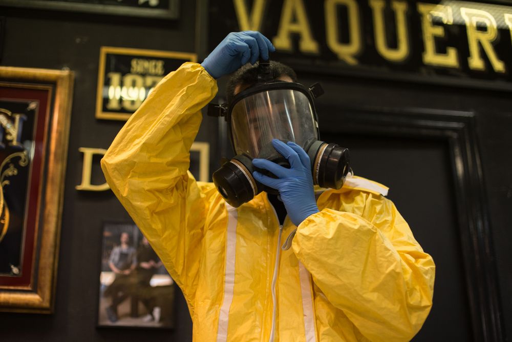 Person getting into PPE before painting to protect from toxic chemicals