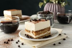 Composition with tasty tiramisu on wooden background. Delicious dessert