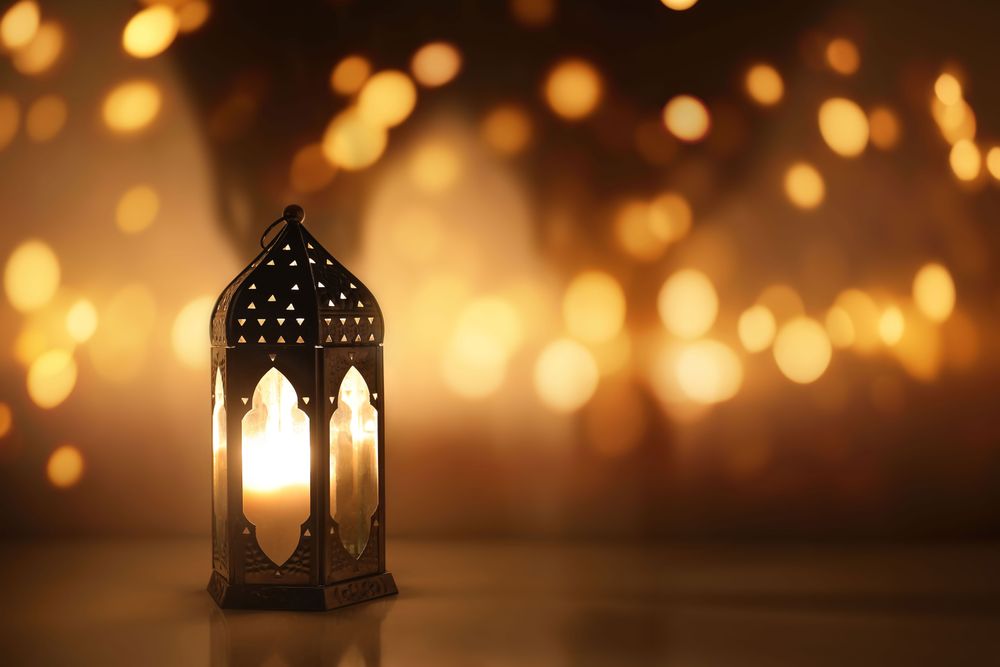 Dark silhouette of Moroccan lantern glowing at night