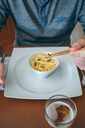 Man eating spaghetti and crickets