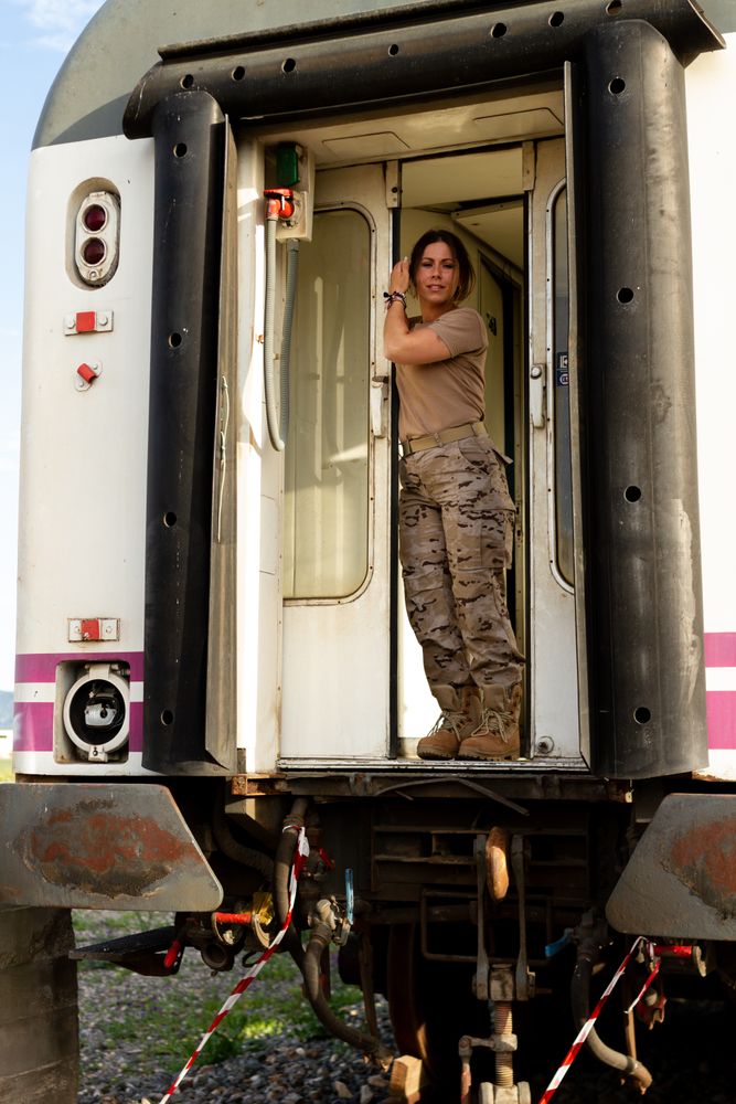 Military woman standing inside railway wagon