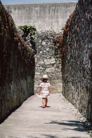 Girl in narrow stone walkway