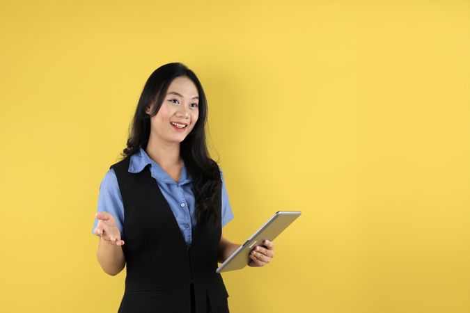 Happy Young Asian Businesswoman in Suit using Tablet Computer on Hand  for Business Presentation