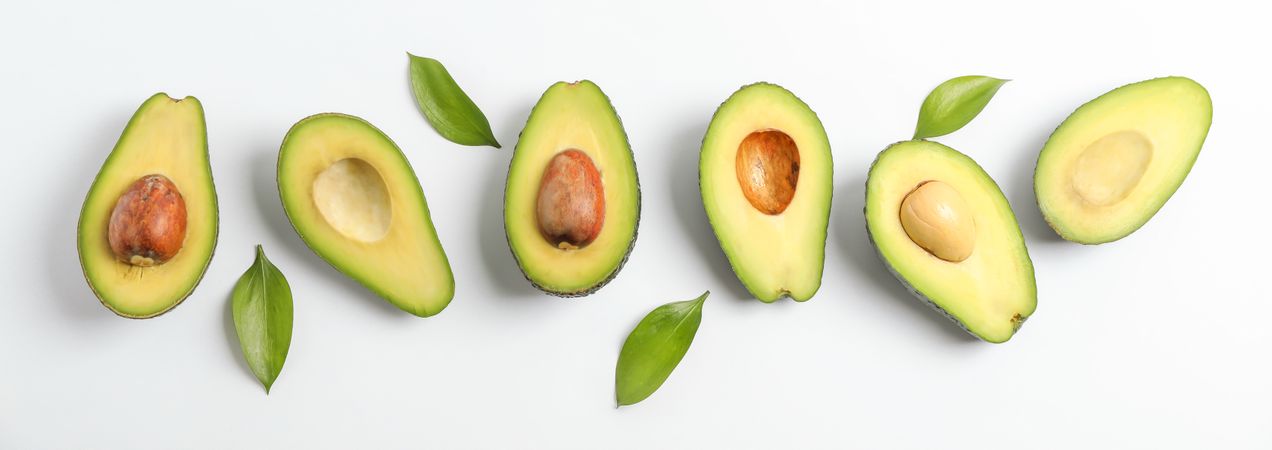 Flat lay composition with ripe avocados on blank background, space for text