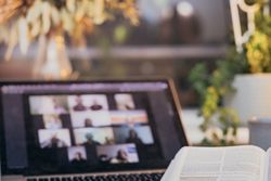 Laptop beside an open book
