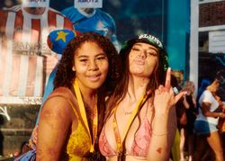 London, England, United Kingdom - August 27, 2022: Two young women splattered in paint on sunny day