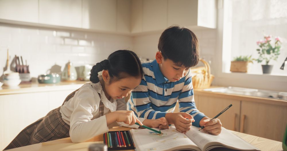 Kids in the Kitchen at Home: Cute Korean Children Are Coloring and Doing Homework While Waiting for Breakfast.