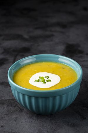 Bowl with pumpkin soup on the table.