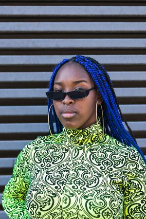 Determined Black woman in trendy clothes in city