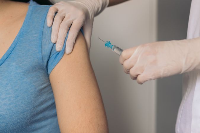 nurse giving a vaccine to a patient.