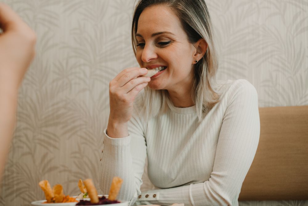 Woman smiling choosing food at table
