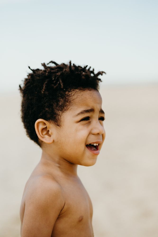 Funny Black boy on beach
