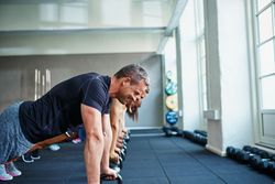 Line of people doing planks in the gym