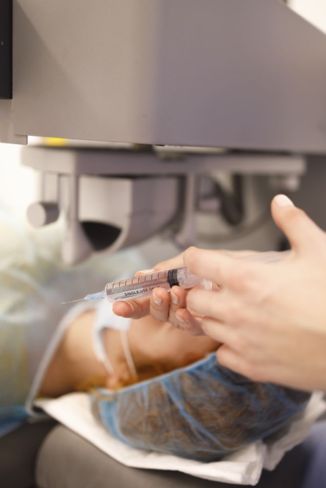 Surgeon holding syringe in operating theater