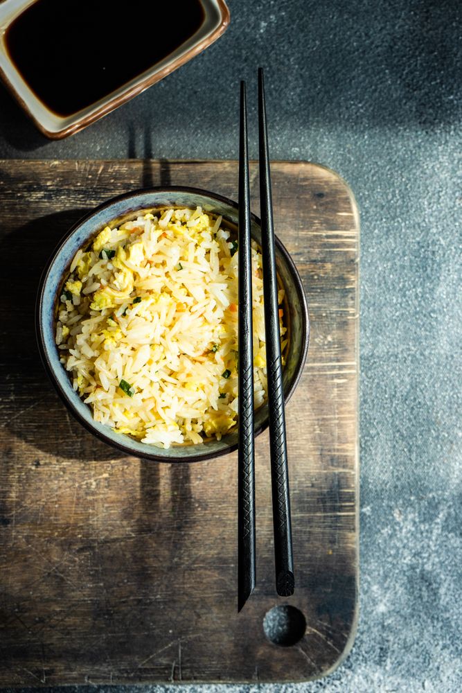 Chinese rice in bowl on wooden board