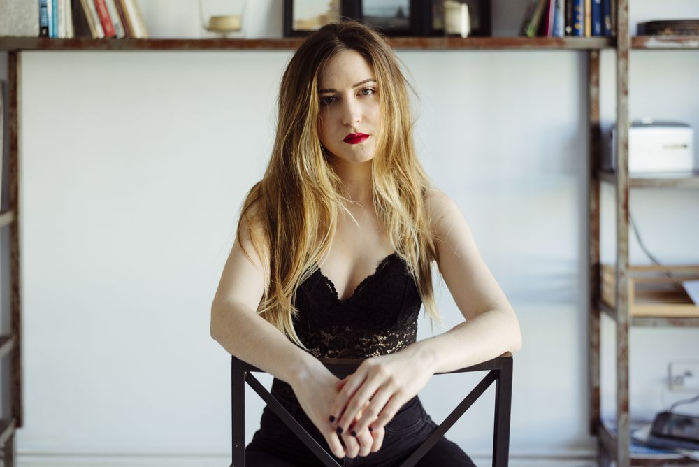 woman in bra sitting on chair