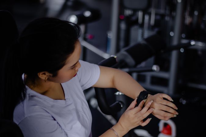 Woman Checking Fitness Tracker During Workout, Health Monitoring