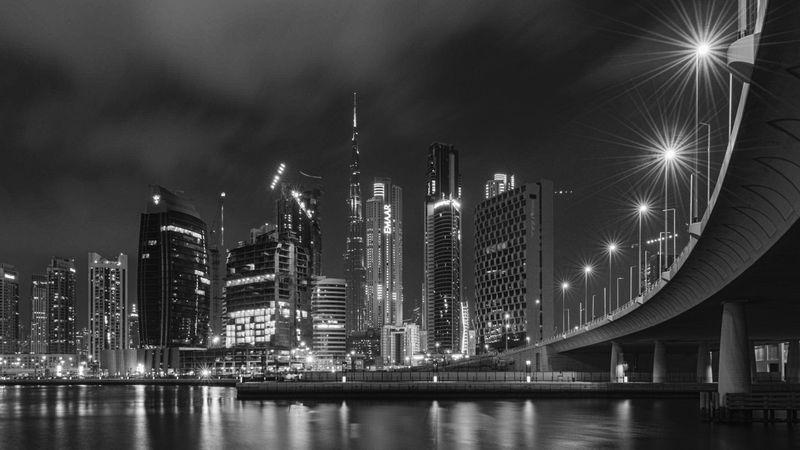 Grayscale photo of city skyline during night time in Dubai, UAE