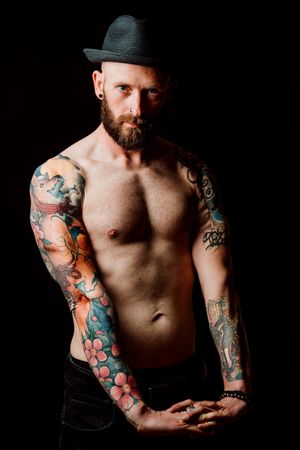 Young shirtless bearded guy with tattoos