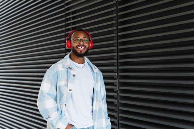 Smiling Black man in headphones and jacket