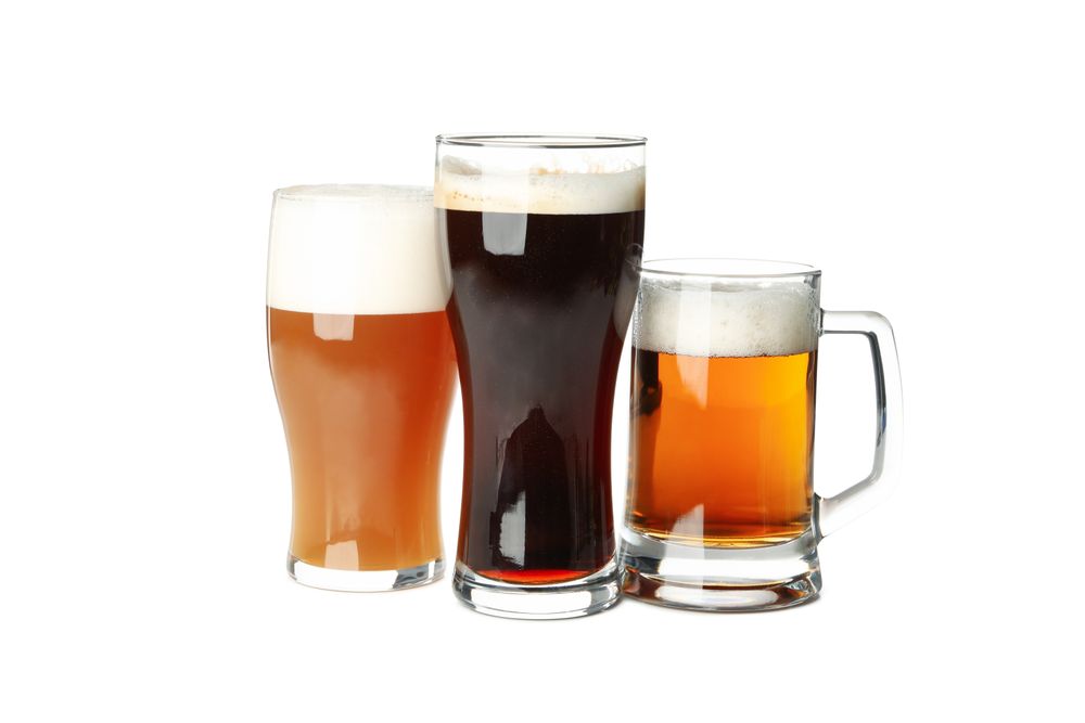 Glasses of beer isolated on light background