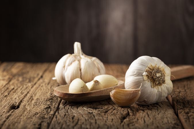 Garlic bulb and garlic cloves on the wooden table.