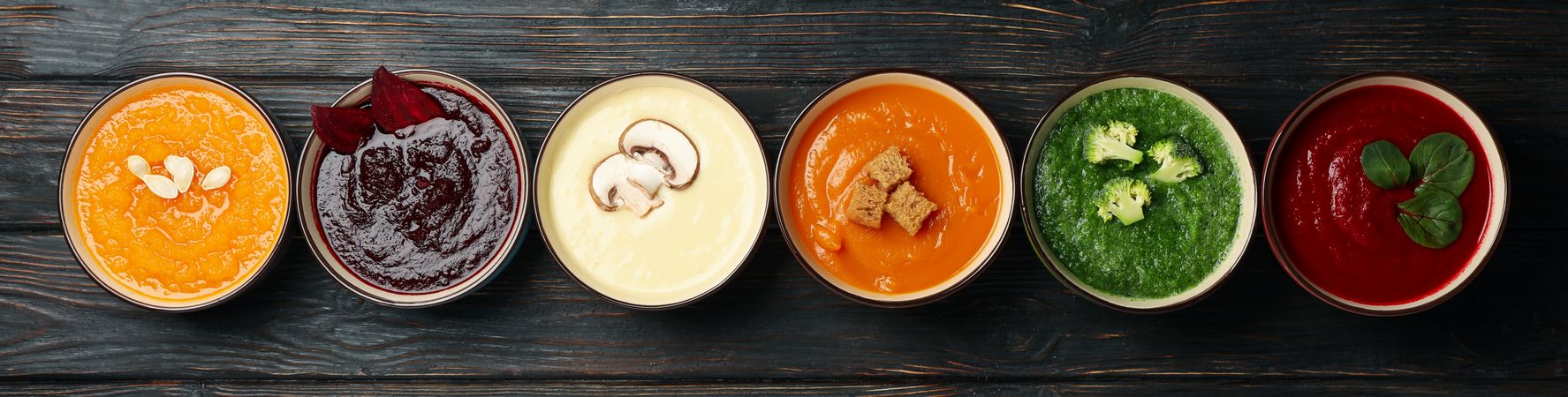 Wide banner of a row of multi-colored soups