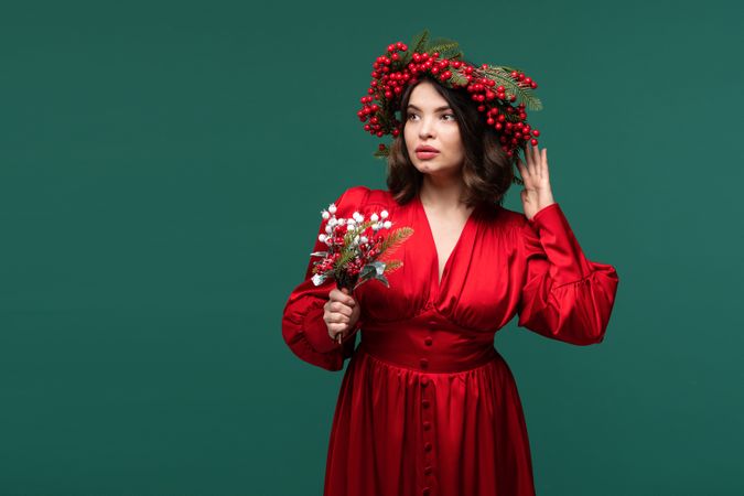 Portrait of woman wearing red dress and berry crown