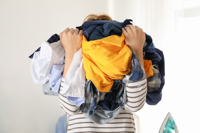 Young woman hold crumpled clothes, space for text