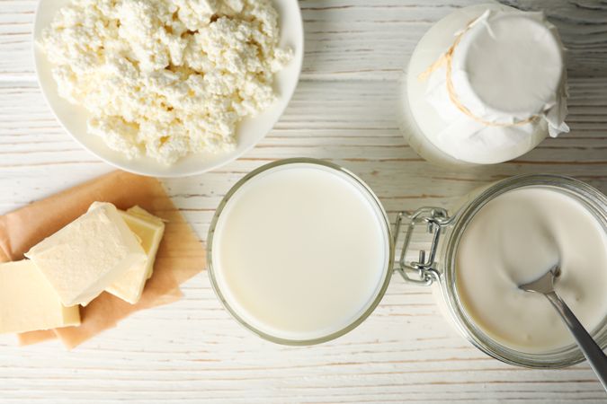 Different dairy products on wooden background, top view