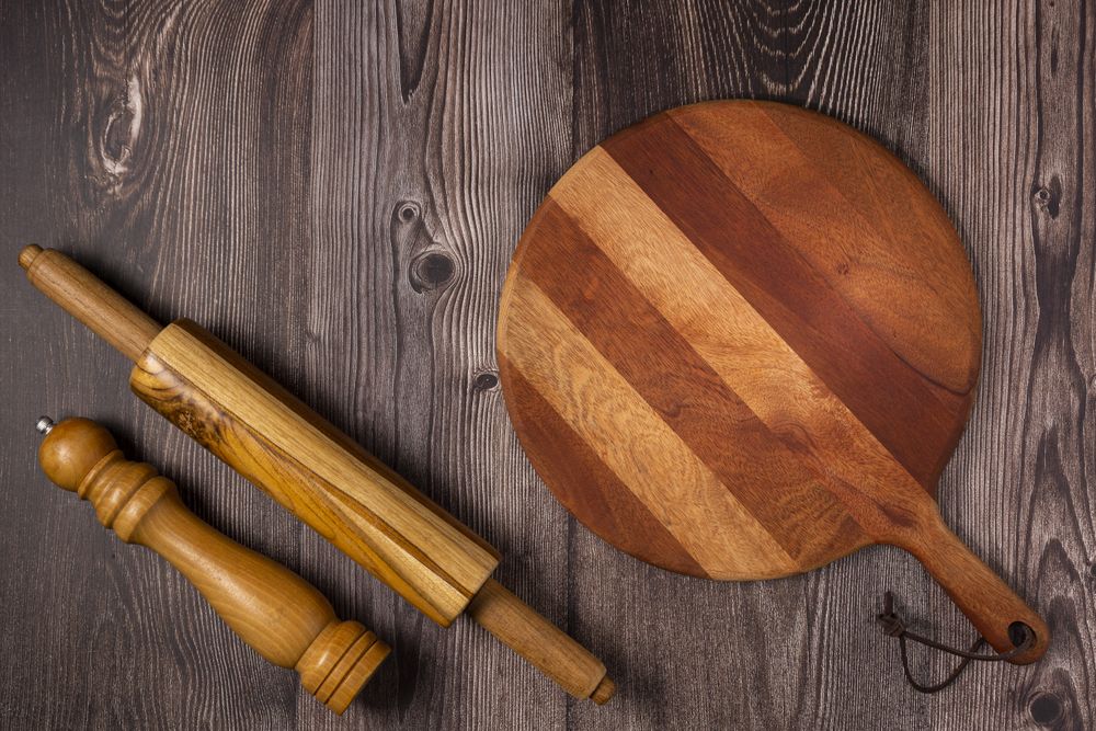 Empty pizza board on rustic wooden table. Top view image.