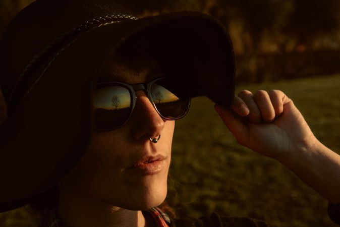 Stylish young woman in felt hat outdoors