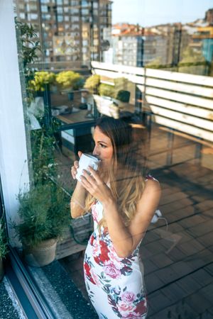 Relaxed woman drinking coffee while watching the views
