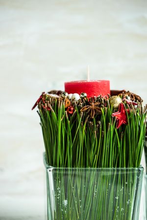 Close up of Christmas candles and spice decor in vase