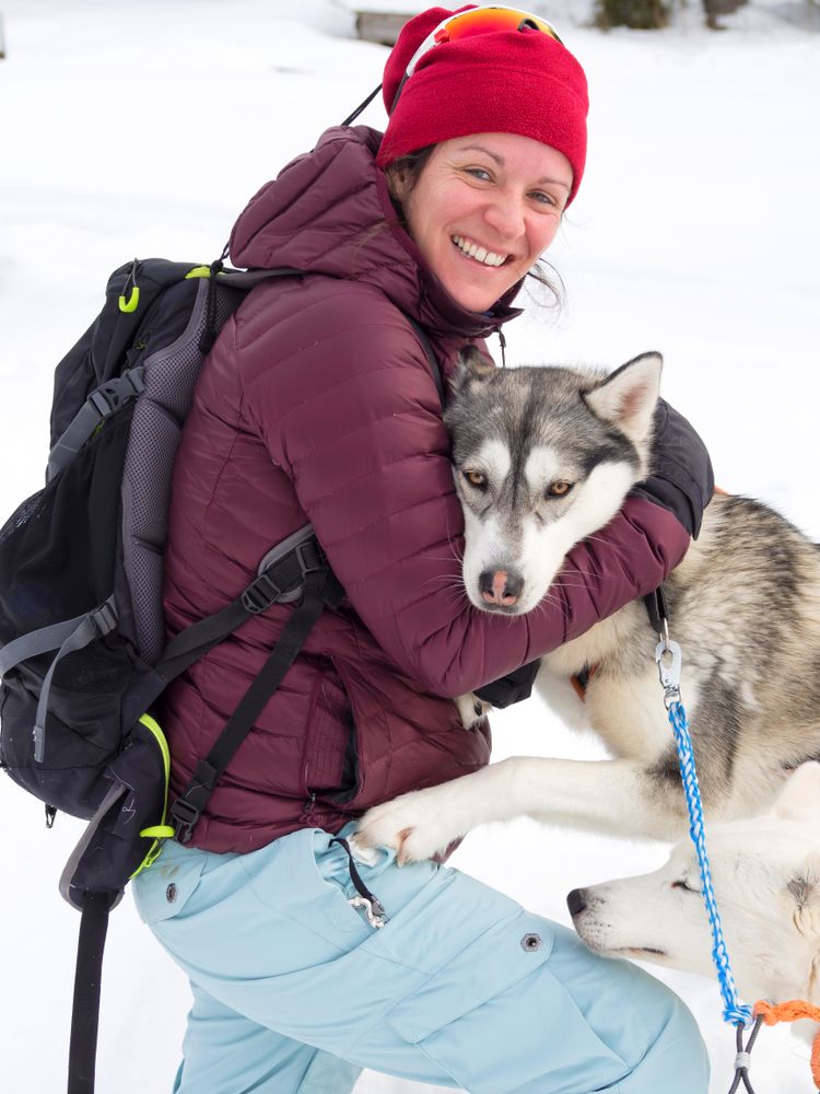 Woman holding husky dog